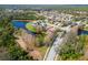 Scenic aerial view of a residential community surrounded by lush greenery and a tranquil lake at 6807 46Th E Ter, Bradenton, FL 34203