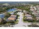 Aerial view of homes in a lakeside community featuring mature landscaping, pools, and serene water views at 6807 46Th E Ter, Bradenton, FL 34203