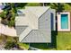 Birds eye view of the detailed roof, pool, and landscaped yard at 6807 46Th E Ter, Bradenton, FL 34203