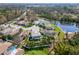 An aerial shot shows the neighborhood, lush greenery, and picturesque pond at 6807 46Th E Ter, Bradenton, FL 34203