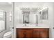 Bathroom featuring double sinks with dark wood cabinetry and tiled shower at 6807 46Th E Ter, Bradenton, FL 34203