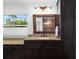 Bathroom featuring granite counters and dark wood cabinetry at 6807 46Th E Ter, Bradenton, FL 34203