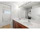 Bathroom featuring a large mirror, double sinks, and a tub with shower at 6807 46Th E Ter, Bradenton, FL 34203