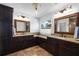 Bathroom featuring double sinks, granite counters, and dark wood cabinetry at 6807 46Th E Ter, Bradenton, FL 34203