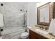 Elegant bathroom featuring a marble tiled shower, granite countertop, and stylish fixtures at 6807 46Th E Ter, Bradenton, FL 34203