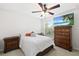 This bedroom features a ceiling fan, large window, and decorative wood furnishings at 6807 46Th E Ter, Bradenton, FL 34203