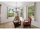 Bright breakfast nook with chandelier and large windows overlooking landscaped yard at 6807 46Th E Ter, Bradenton, FL 34203