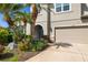 Close up of two story home with a two car garage and well manicured tropical landscaping at 6807 46Th E Ter, Bradenton, FL 34203