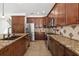 Spacious kitchen featuring granite counters, stainless steel appliances, and wooden cabinets at 6807 46Th E Ter, Bradenton, FL 34203