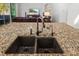 Close up of kitchen island, featuring granite countertop and double sink at 6807 46Th E Ter, Bradenton, FL 34203