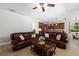 Open living room showcasing leather sofas, decorative pillows, and a seamless flow to the kitchen at 6807 46Th E Ter, Bradenton, FL 34203