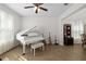 A living room features a white piano, tile flooring, and neutral paint at 6807 46Th E Ter, Bradenton, FL 34203