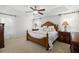 Comfortable main bedroom with a tray ceiling, ceiling fan, and neutral-toned decor at 6807 46Th E Ter, Bradenton, FL 34203