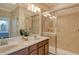 Well-lit bathroom with double vanity, tiled shower, and modern fixtures at 7212 Ketch Pl, Bradenton, FL 34212