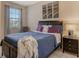 Stylish bedroom featuring a dark wood bed frame, accent pillows, and modern artwork at 7212 Ketch Pl, Bradenton, FL 34212