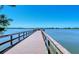 Scenic wooden dock extending over a tranquil lake with a serene and calm waterscape at 7212 Ketch Pl, Bradenton, FL 34212