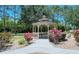 Inviting gazebo surrounded by landscaped gardens and mature trees in a well-maintained community at 7212 Ketch Pl, Bradenton, FL 34212