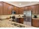 Kitchen featuring stainless steel appliances, granite counters and wood cabinets at 7212 Ketch Pl, Bradenton, FL 34212