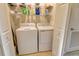 Well-organized laundry room with a washer, dryer, and shelving at 7212 Ketch Pl, Bradenton, FL 34212