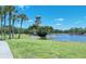 Beautiful view of the lighthouse surrounded by a lake, palm trees and greenery in a serene community at 7212 Ketch Pl, Bradenton, FL 34212