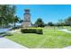 Scenic view of the lighthouse by a lake with lush greenery, and tranquil waterscape in a well-maintained community at 7212 Ketch Pl, Bradenton, FL 34212