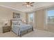 Serene bedroom with soft colors, plush bedding, and windows offering natural light and relaxing ambiance at 7212 Ketch Pl, Bradenton, FL 34212