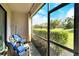 Enclosed patio featuring seating and a view of lush landscaping at 7212 Ketch Pl, Bradenton, FL 34212