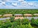 Aerial view of community with townhouses and lush greenery at 7350 Black Walnut Way, Lakewood Ranch, FL 34202