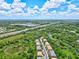 Aerial view of townhouses near a highway and waterway at 7350 Black Walnut Way, Lakewood Ranch, FL 34202