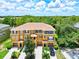 Aerial view of a three-story townhouse with two-car garage at 7350 Black Walnut Way, Lakewood Ranch, FL 34202