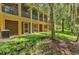 Backyard view of townhouses with screened patios and lush landscaping at 7350 Black Walnut Way, Lakewood Ranch, FL 34202