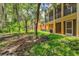 Backyard of a townhouse featuring lush landscaping and trees at 7350 Black Walnut Way, Lakewood Ranch, FL 34202