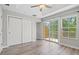 Bright bedroom with wood-look floors, large closet, and sliding glass door to balcony at 7350 Black Walnut Way, Lakewood Ranch, FL 34202