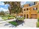 Three story townhome with a two-car garage and a magnolia tree at 7350 Black Walnut Way, Lakewood Ranch, FL 34202