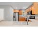 Updated kitchen featuring stainless steel appliances and light wood cabinets at 7350 Black Walnut Way, Lakewood Ranch, FL 34202