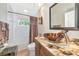 Bathroom with custom vessel sink, granite countertop, decorative mirror, and shower/tub combo at 779 Fordingbridge Way, Osprey, FL 34229