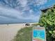 Beach view with a rip current warning sign, sandy dunes, and ocean scenery in the background at 779 Fordingbridge Way, Osprey, FL 34229