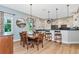 Dining area featuring a chandelier, modern kitchen with stainless steel appliances and bar seating at 779 Fordingbridge Way, Osprey, FL 34229