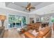 Living room with sliding glass doors to screened lanai and open to the dining room at 779 Fordingbridge Way, Osprey, FL 34229