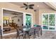 Outdoor patio with dining table, ceiling fan, travertine flooring, and seamless transition to indoor living at 779 Fordingbridge Way, Osprey, FL 34229