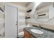 Small bathroom with granite countertop, toilet, and striped walls at 7805 Capwood Ave, Temple Terrace, FL 33637