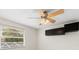 Bedroom with window, ceiling fan and wall cabinets at 7805 Capwood Ave, Temple Terrace, FL 33637