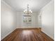 Dining room with hardwood floors, chandelier, and window at 7805 Capwood Ave, Temple Terrace, FL 33637