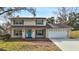 Two-story house with a stone facade, two-car garage, and landscaped lawn at 7805 Capwood Ave, Temple Terrace, FL 33637