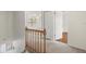 Upstairs hallway with wood railing and carpet at 7805 Capwood Ave, Temple Terrace, FL 33637