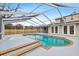 Spacious pool area with covered patio and spa at 7805 Capwood Ave, Temple Terrace, FL 33637