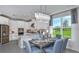 Dining area adjacent to kitchen with a gray table and blue chairs at 8437 Skye Ranch Blvd, Sarasota, FL 34241