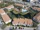 Aerial view of community with pool, tennis court, and pond at 850 S Tamiami Trl # 724, Sarasota, FL 34236