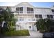 Condo building with stairs, balconies, and tropical landscaping at 850 S Tamiami Trl # 724, Sarasota, FL 34236