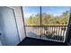 Screened balcony overlooking a parking lot and trees at 850 S Tamiami Trl # 724, Sarasota, FL 34236